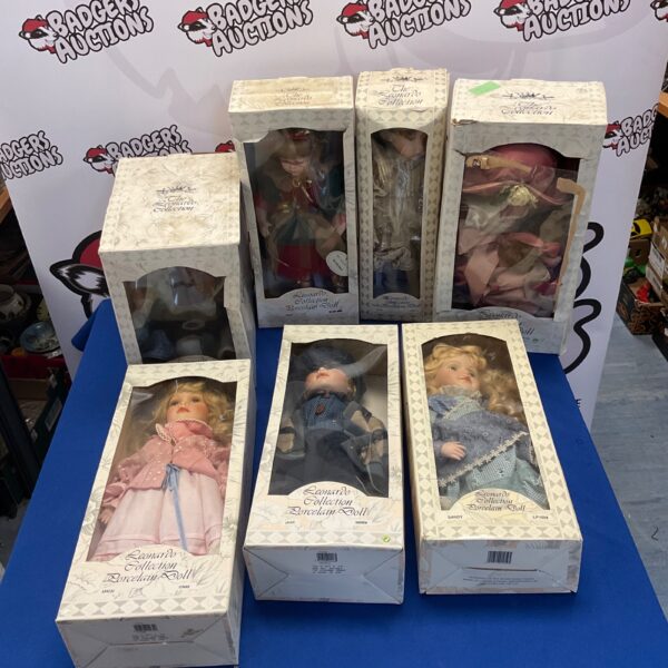 Lot of seven Leonardo Collection porcelain dolls displayed together.