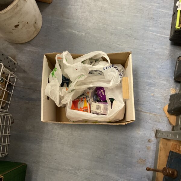 Assorted light bulbs in a cardboard box and plastic bags.