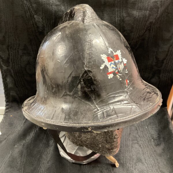 Vintage London Fire Brigade helmet with crest displayed.