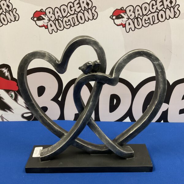Metal love birds sculpture forming a heart shape for home decor.