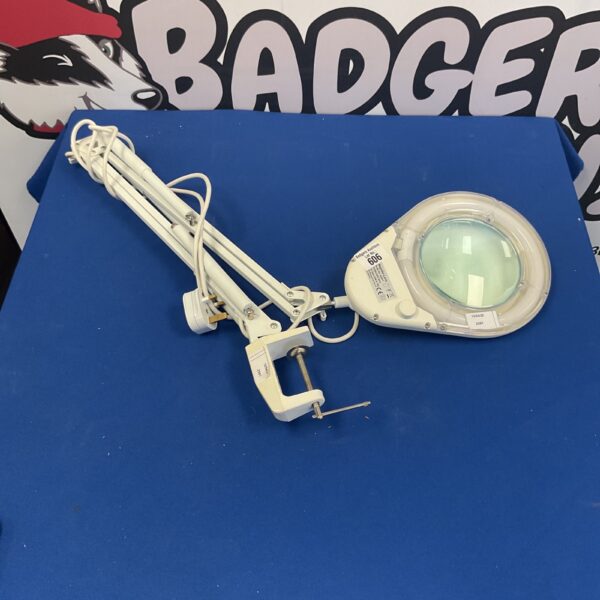 Adjustable magnifying desk lamp with flexible arm and lens.
