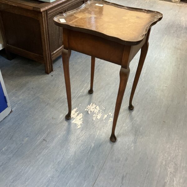 Vintage mahogany piecrust table with carved legs.