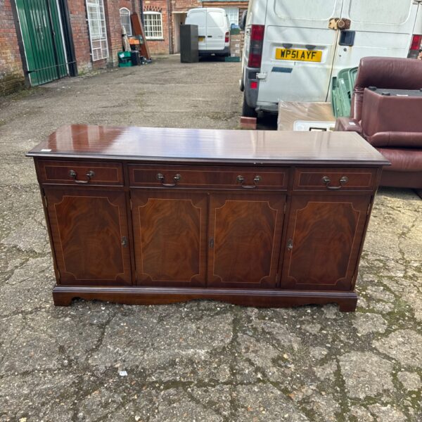 Front view of a mahogany sideboard cabinet with inlaid details.