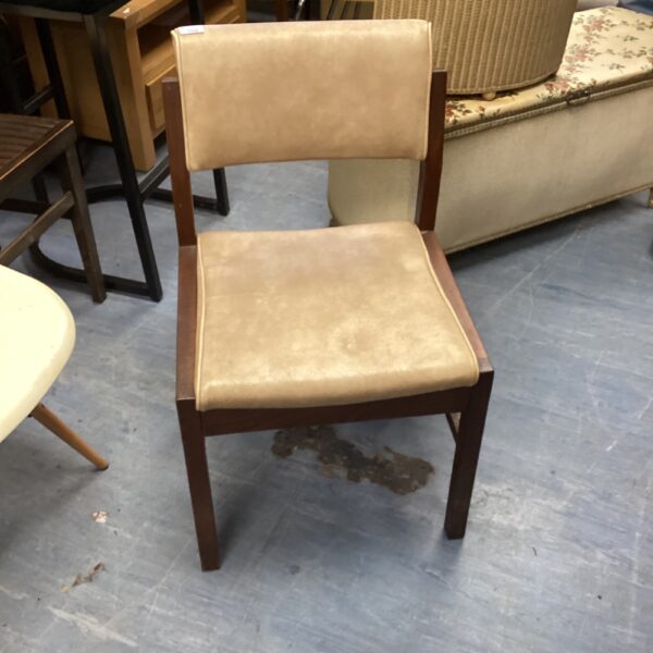 Vintage mahogany upholstered chair with classic mid-century design.