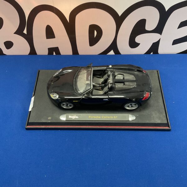 Detailed Maisto Porsche Carrera GT diecast model car on display.