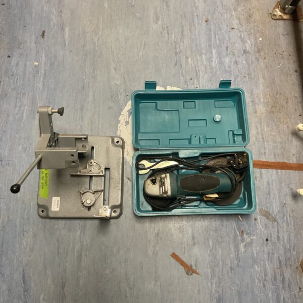 Used Makita angle grinder on metal cutting stand for workshop use.