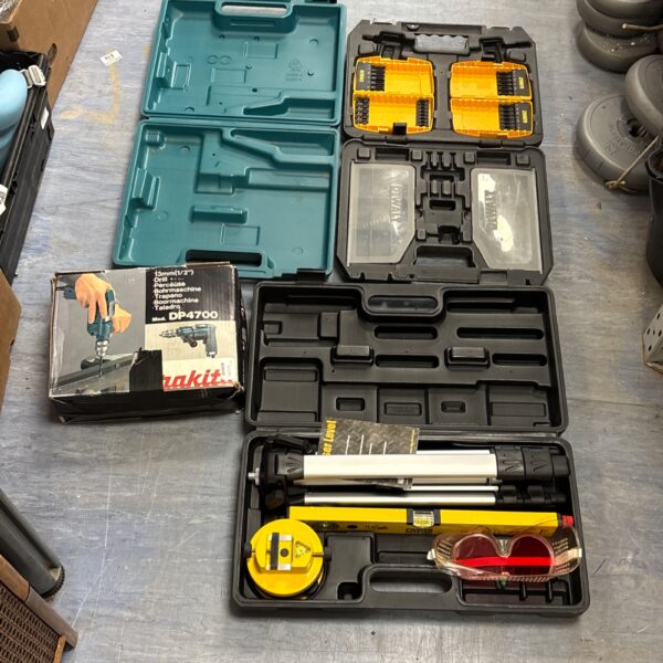 Makita DP4700 drill and laser level kit in Dewalt case.