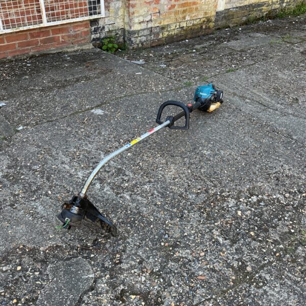 Used Makita petrol strimmer for garden and landscaping tasks.