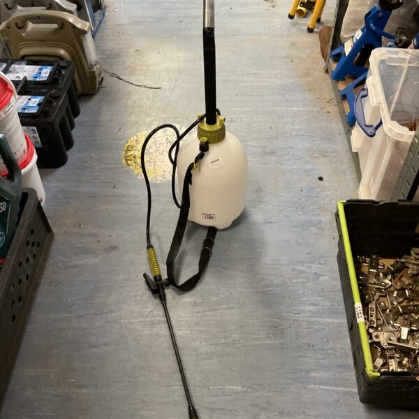 Manual pressure sprayer for garden use, showing wear and tear.