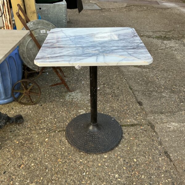 Stylish marble topped garden table with black metal base.
