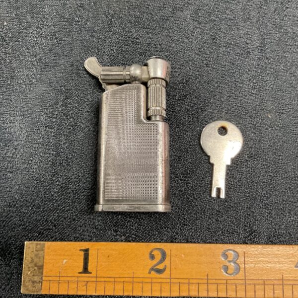 Vintage Maruman cigarette lighter with key and ruler.