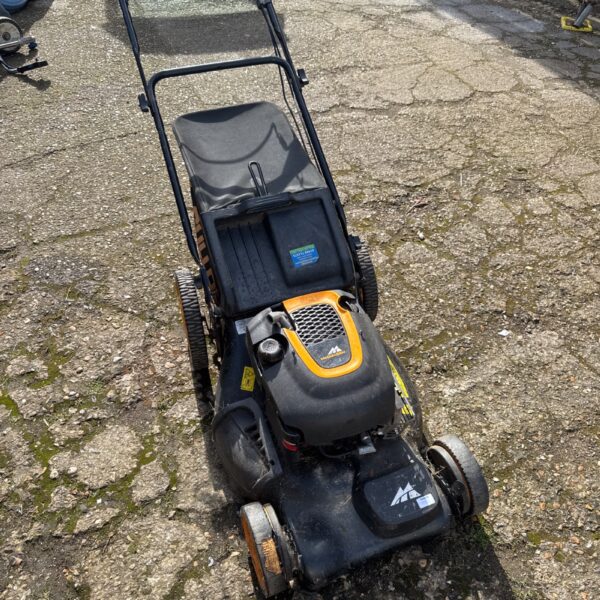 McCulloch M53 petrol lawnmower with grass box in garden setting.