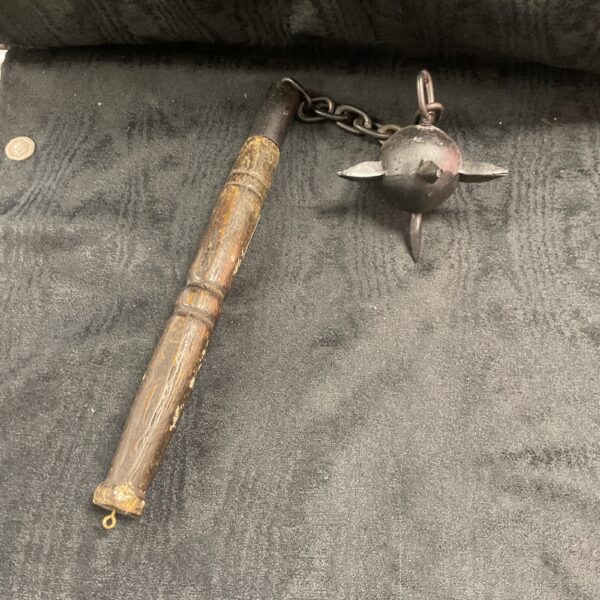 Medieval chain mace with a flanged head and wooden handle.