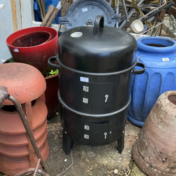 Used metal barbecue grill for outdoor cooking.
