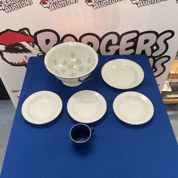 Metal collider set with plates and mug for kitchen dining.
