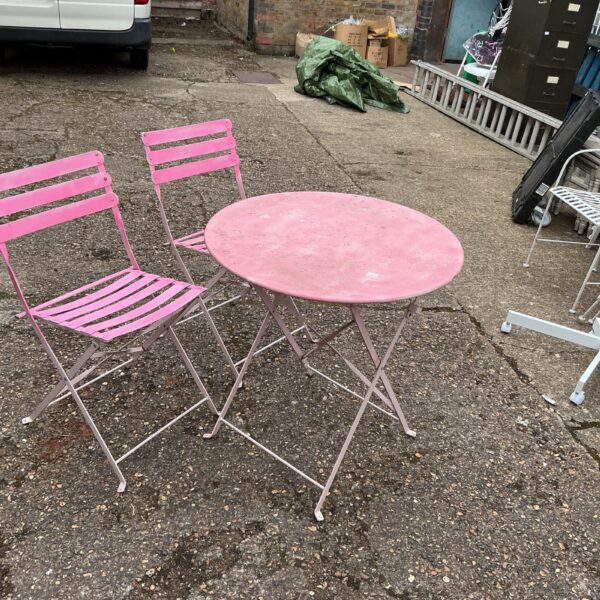 Vintage metal garden bistro set with table and two chairs.