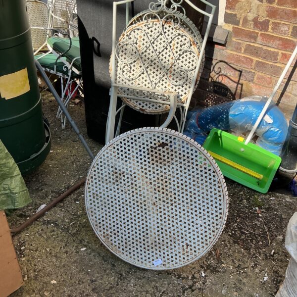 Vintage metal garden furniture set with pierced metalwork.