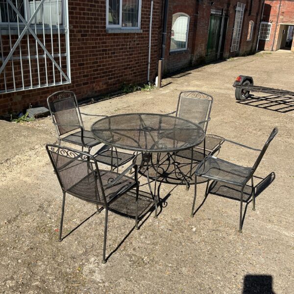 Dark metal garden patio set with table and four chairs.