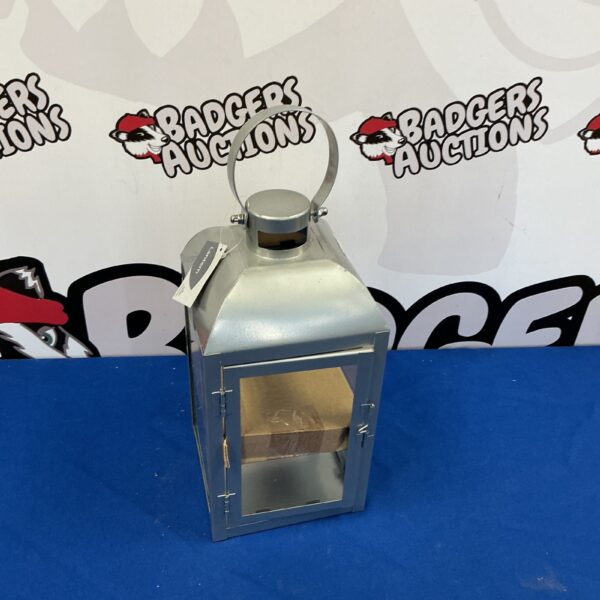 Vintage metal lantern with handle, ideal for candles.