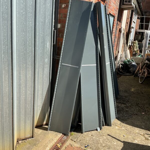 Quantity of metal workshop shelving units for storage.