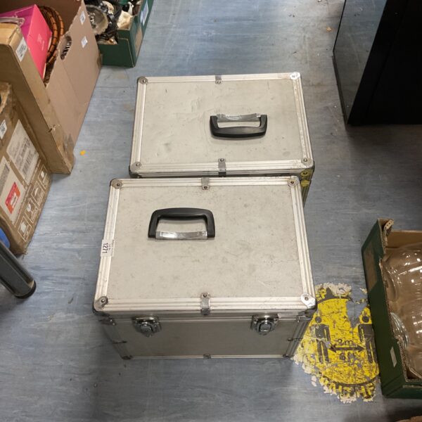 Pair of vintage metal storage trunks with handles.