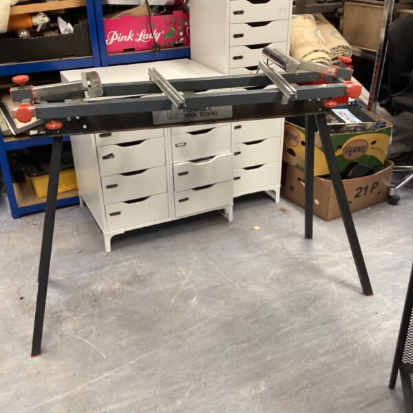 Metal tool stand in a workshop setting, providing a stable work surface.