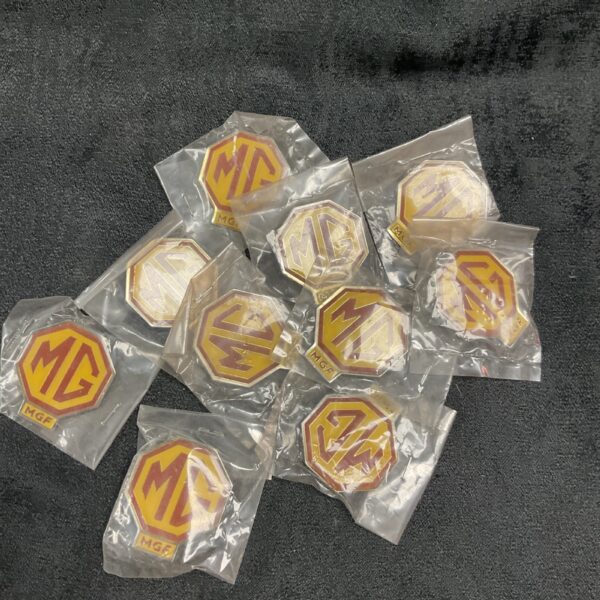 Lot of ten MG pin badges for collectors.