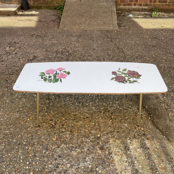 Vintage mid-century coffee table with floral pattern.