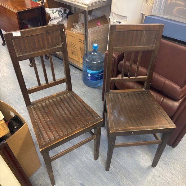 Pair of vintage mid-century mahogany chairs with curved backs.