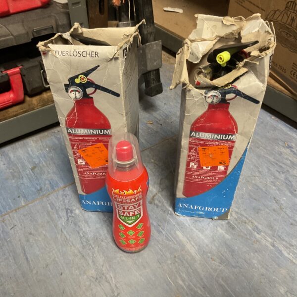 Lot of vintage miniature fire extinguishers in original packaging.