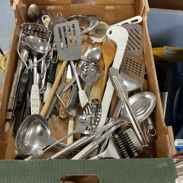 Mixed cutlery lot with stainless steel serving spoons and utensils.