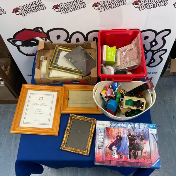 Mixed lot of toys, frames, and a Disney Frozen 2 puzzle.