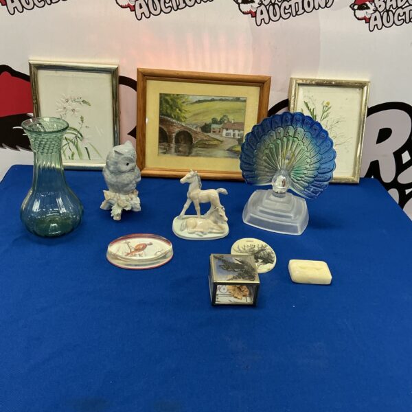 Mixed ornament collection featuring a glass peacock and porcelain figurines.