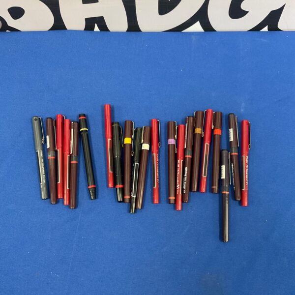 Mixed lot of red and black pens for writing and collecting.