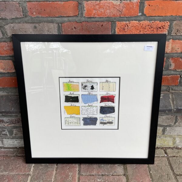 Framed modern calendar print with abstract geometric design.