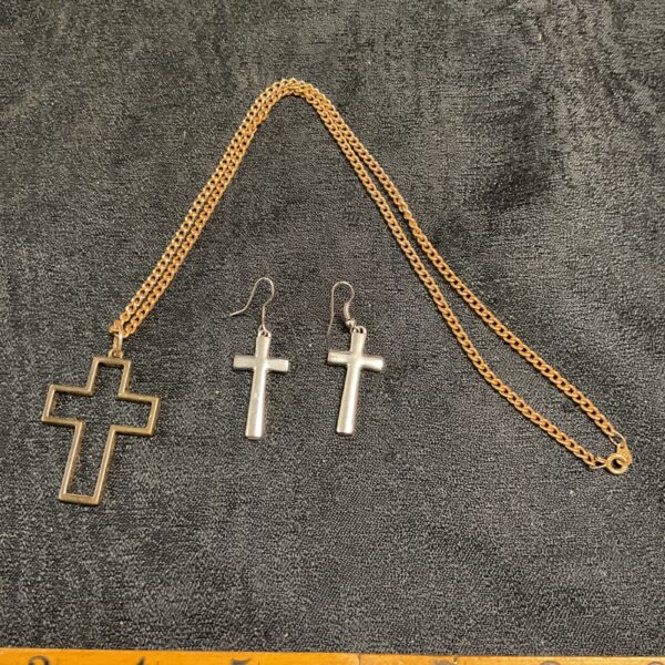 Vintage modernist crucifix necklace and earring set in gold tone.
