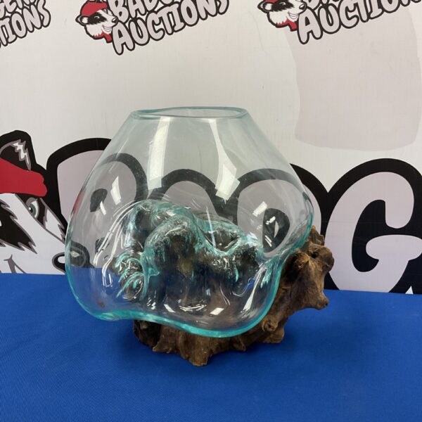 Handmade molten glass bowl on a teak wood root base.