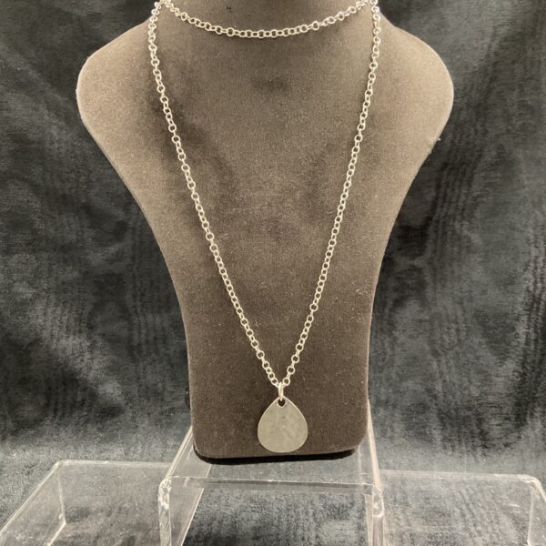 Monica Vinada silver necklace displayed on a mannequin.