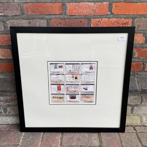 Framed monthly letter stamps print for vintage wall decor.