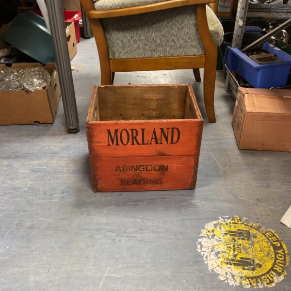 Vintage Morland Brewery wooden crate, showing wear and branding.