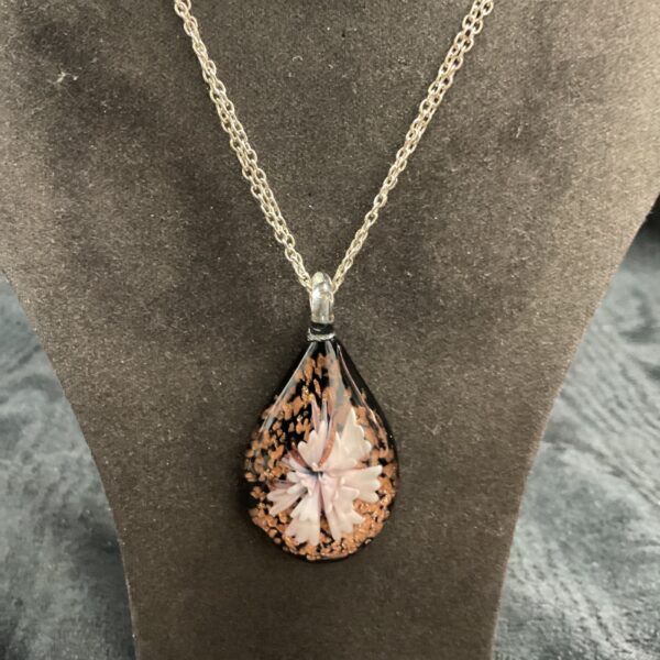 Close-up of a beautiful Murano glass pendant with floral design.