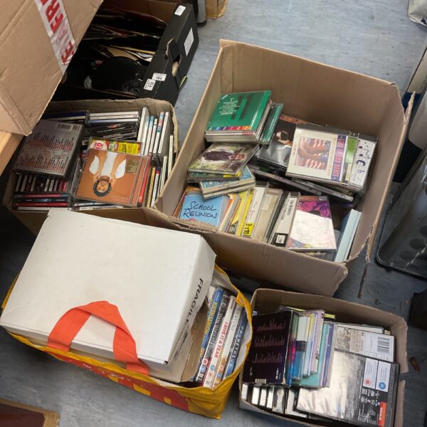 Large lot of music CDs and DVDs for collectors and entertainment.
