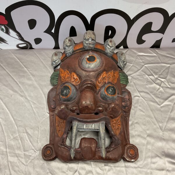 Hand-carved Nepalese Bhairab mask with fierce expression.
