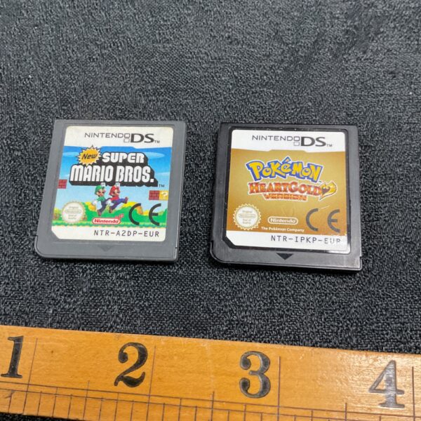 Nintendo DS game lot featuring Super Mario Bros and Pokemon HeartGold cartridges.