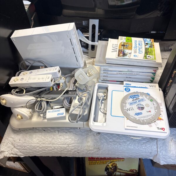 Nintendo Wii console bundle with games and accessories displayed.