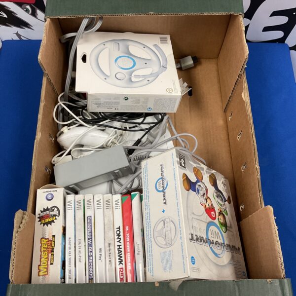Nintendo Wii console with games and steering wheel accessory.