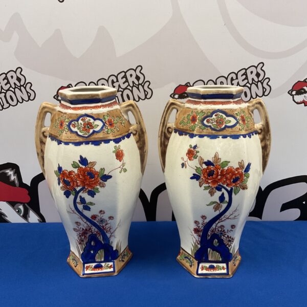 Antique Nippon hand-painted porcelain vases with floral designs.