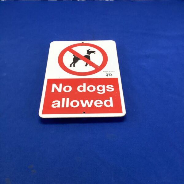 Vintage ‘No Dogs Allowed’ sign with a red prohibition symbol.