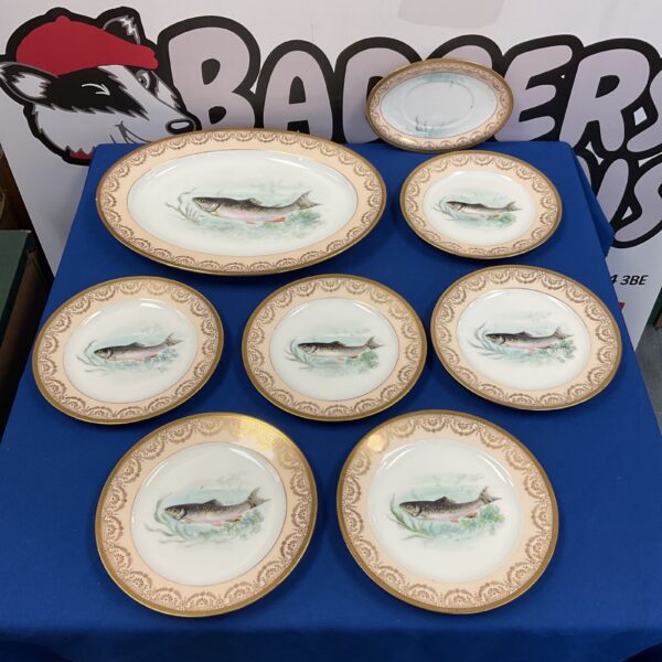 Vintage Noritake fish pattern plates on a blue background.