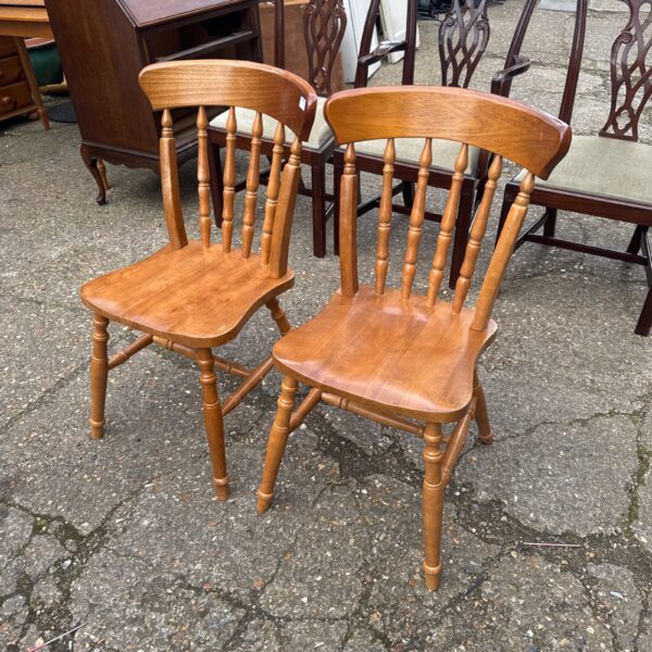 Pair of vintage oak dining chairs with spindle backs.